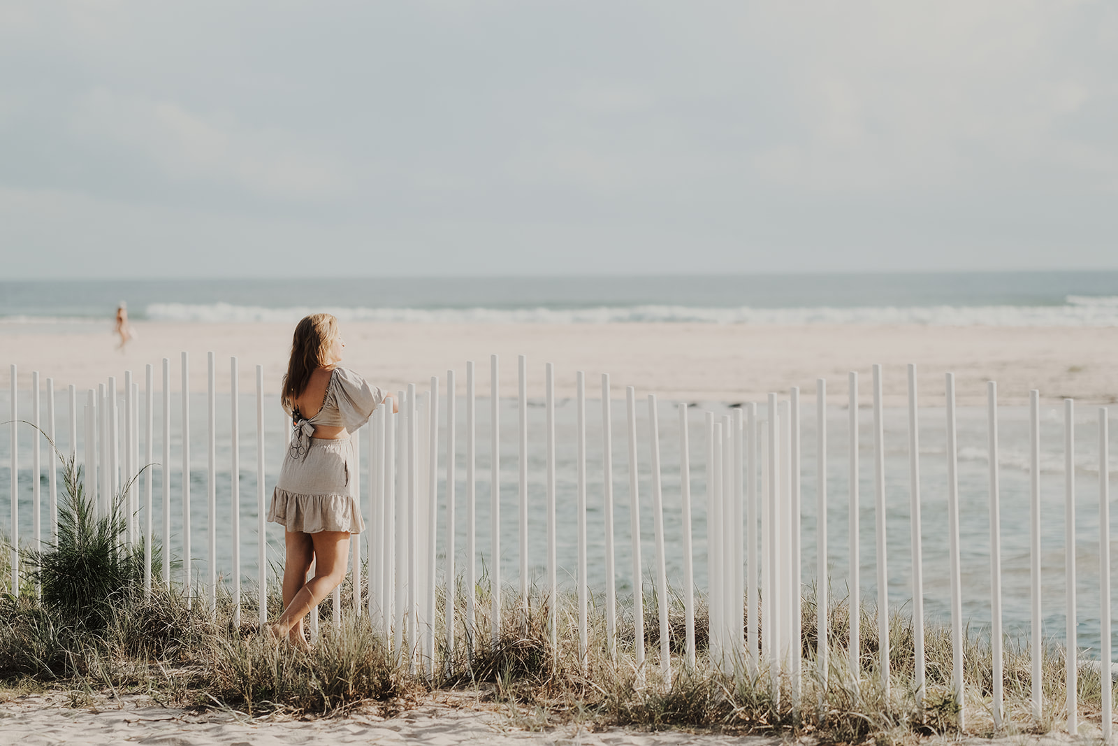 Vicky Samios looking out to the ocean beside a white fence